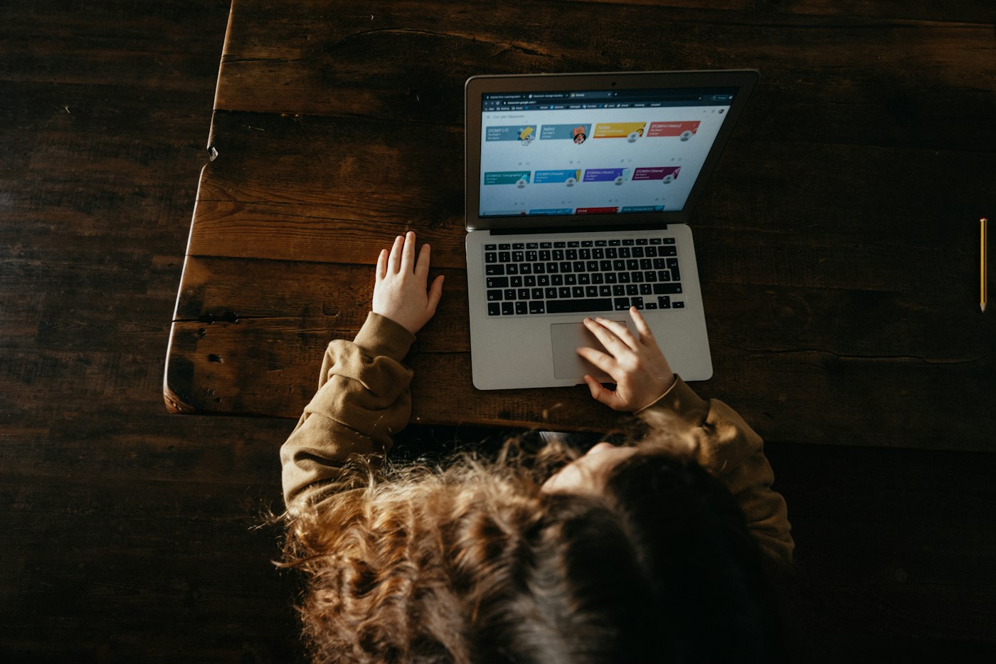 A child working through an online lesson on a laptop at home